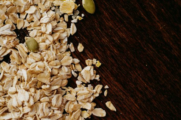 pexels-photo-2290075-2290075 High-angle view of oats, cornmeal, and seeds on a dark wooden table. Perfect for healthy food themes.